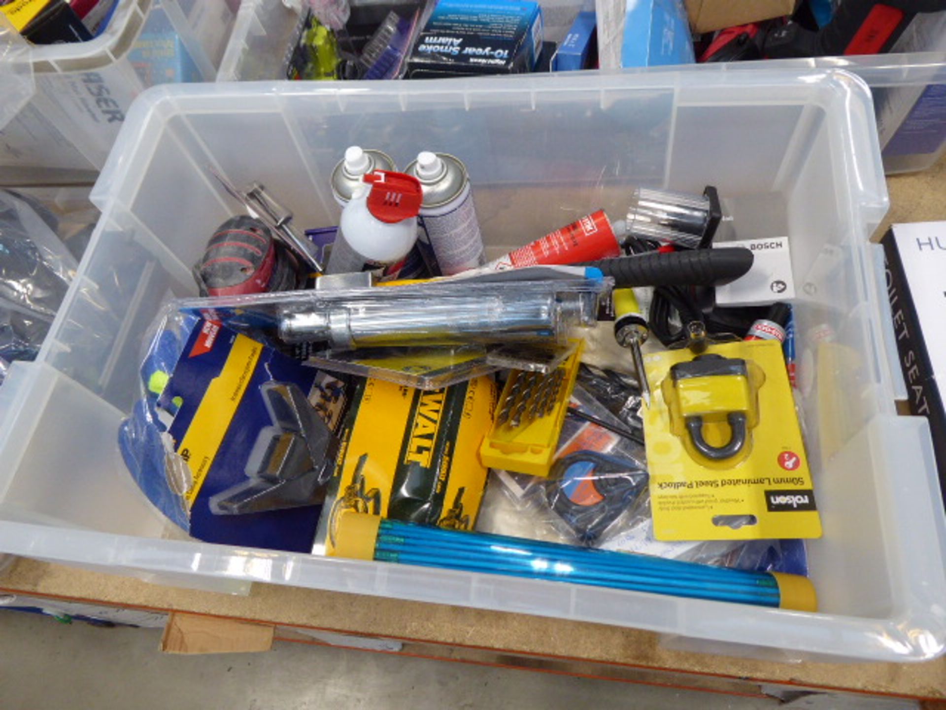 Large box containing security locks, cable access kit, grease gun, hatchet, adhesive, etc