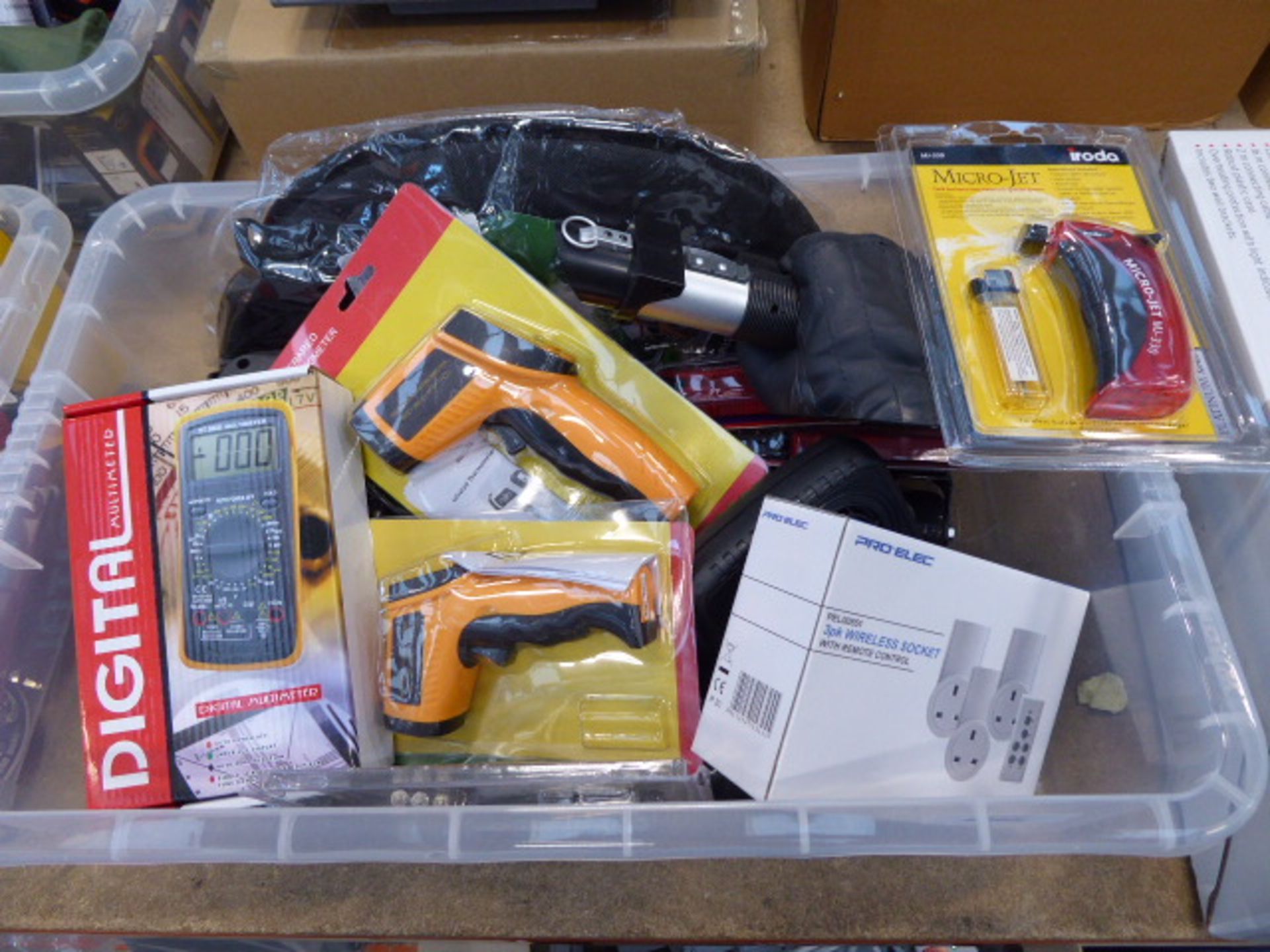 Plastic crate containing digital multimeter, infrared thermometers, mini screwdrivers, castors,