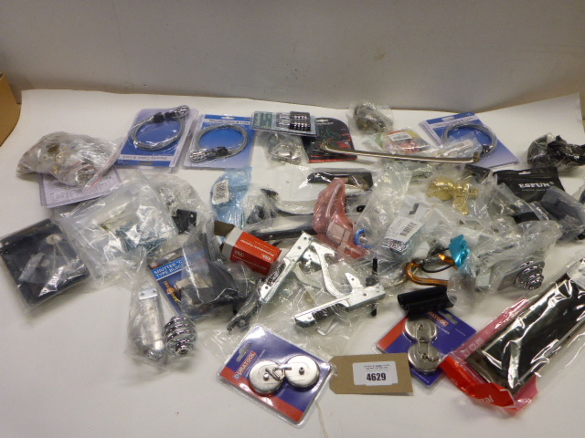 Bag containing locks, cylinders, magnetic hooks, brackets, padlocks, security cable locks, door