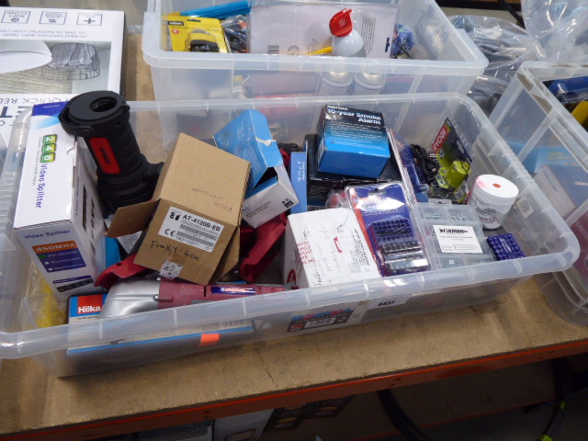 Large plastic box containing security bit sets, torches, smoke alarms, batteries, etc