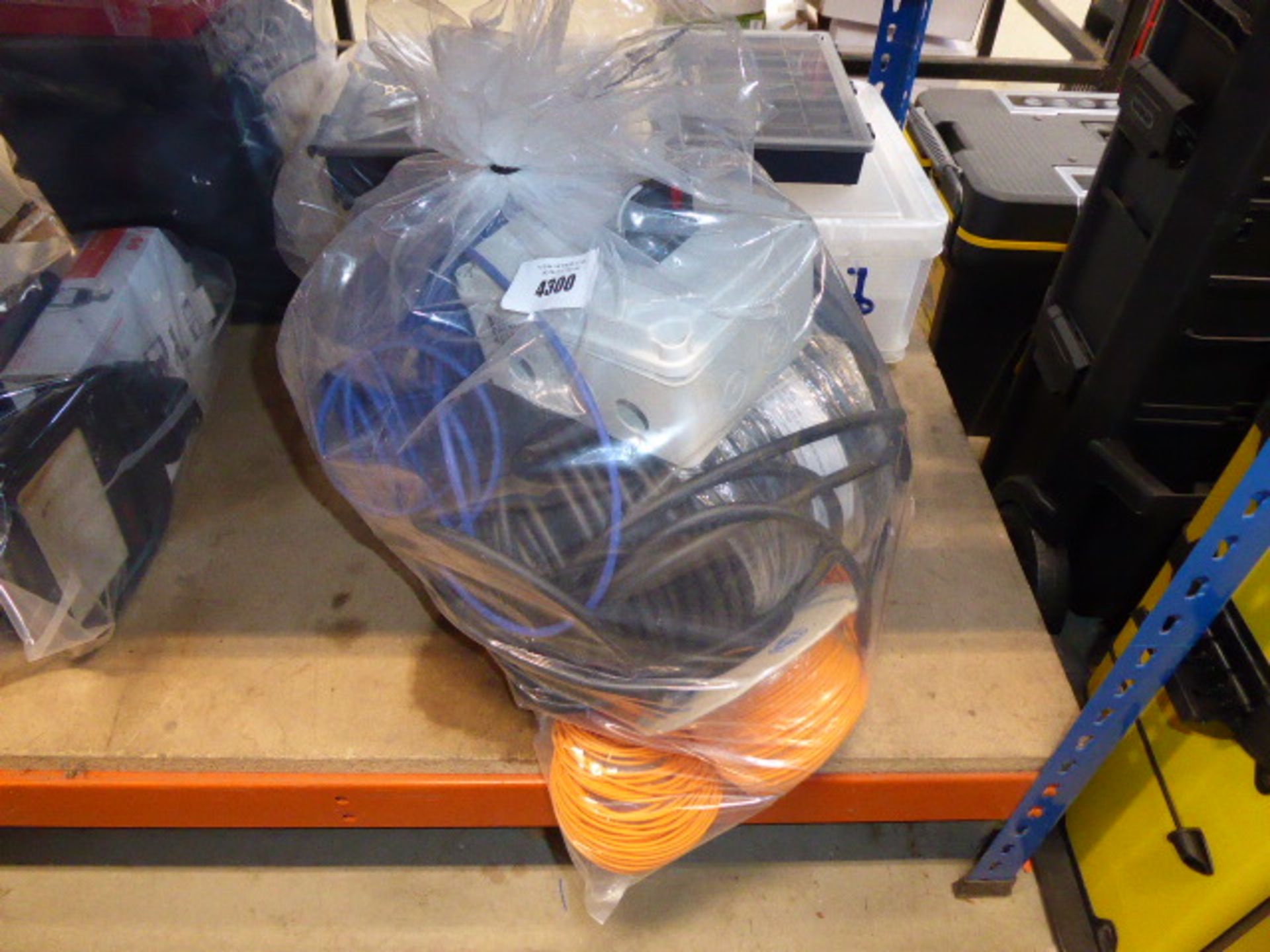 Bag containing orange cable, black cable rubber and a junction box