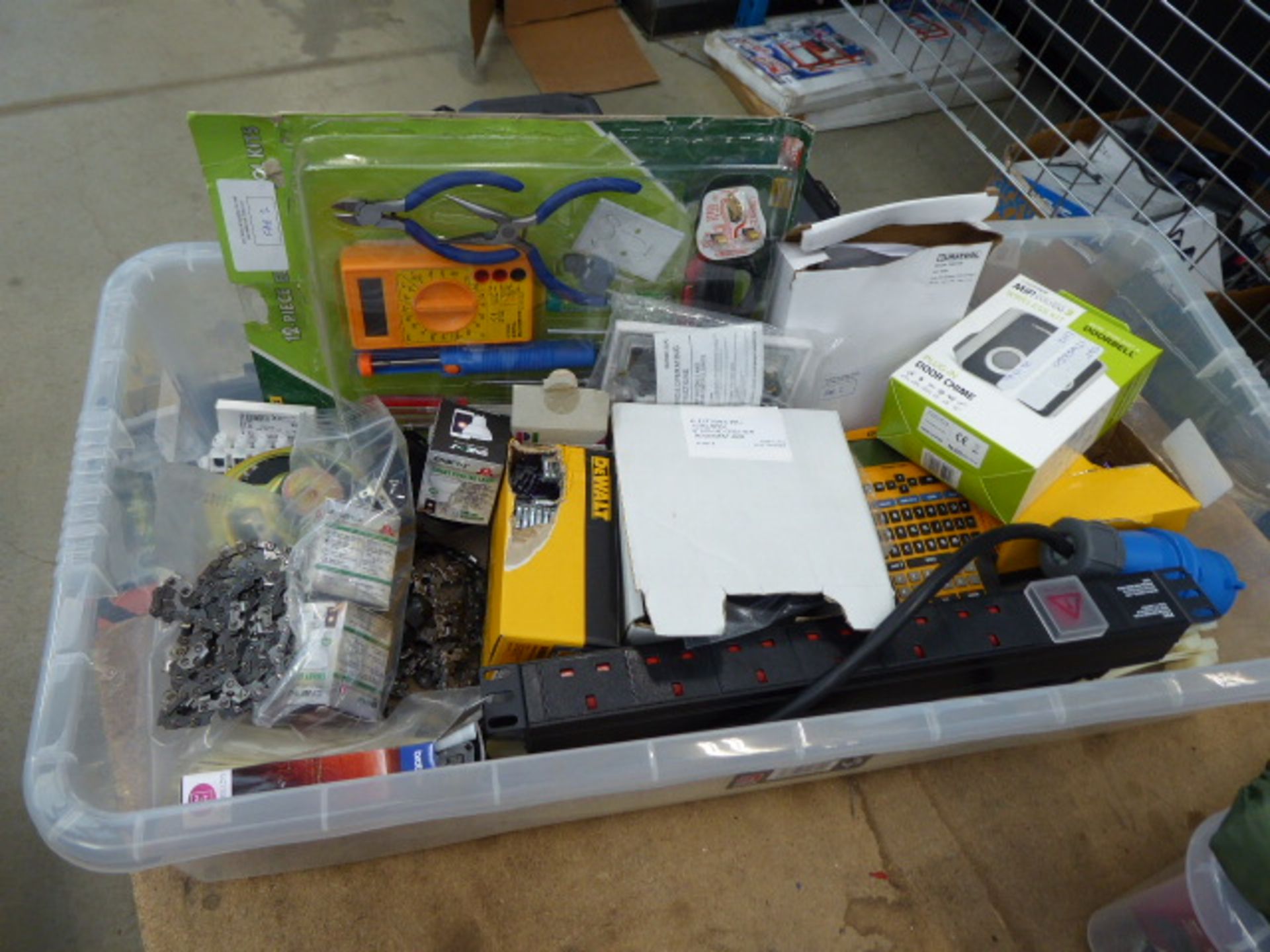 Box containing chainsaw blades, lights, wireless doorbell, extension cable, multimeter, etc