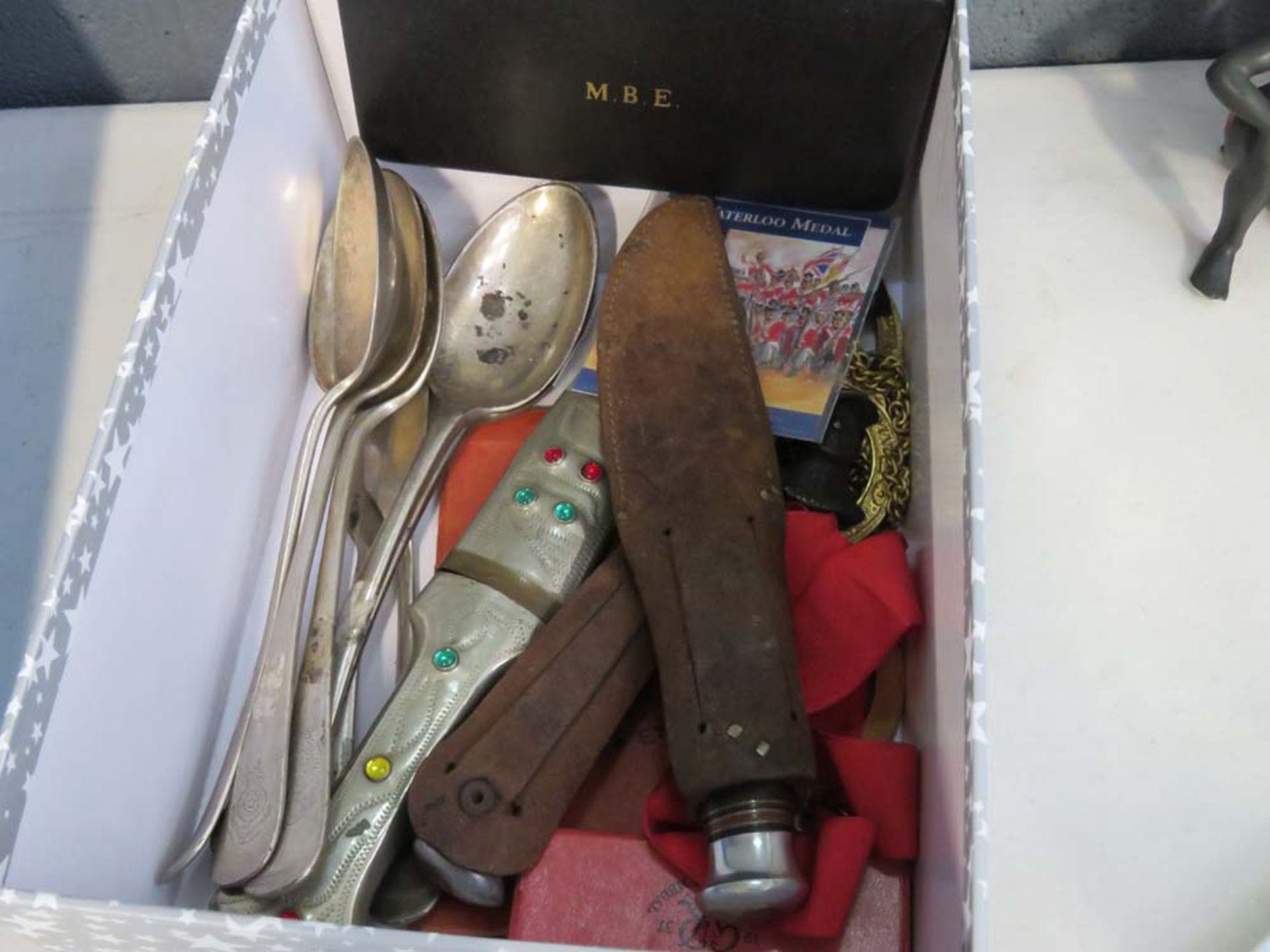 Box containing knives, silver plated spoons, plus medallions