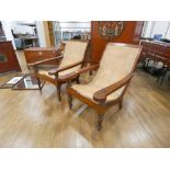 A pair of Anglo-Indian caned plantation chairs with pivoting leg rests, max w. 73 cm