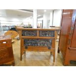 A late 20th century Oriental altar style table made for use as a TV cabinet, decorated with