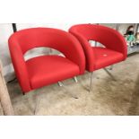 Pair of red upholstered tub style reception chairs on 4 star metal bases by boss design group