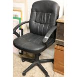 Black upholstered swivel office armchair