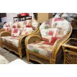 Cane conservatory suite comprising 2 seater sofa, 2 matching armchairs and 2 coffee tables