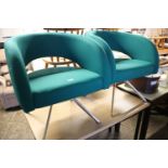 Pair of green upholstered tub style reception chairs on 4 star metal bases by boss design group