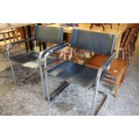 Pair of tubular framed metal armchairs with black vinyl seats and backs