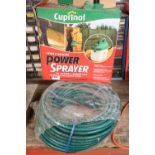 Reel of hose and boxed Cuprinol garden sprayer