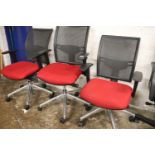 3 red upholstered swivel office armchairs on 5 star chrome bases