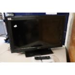 Sony Bravia flat screen TV with stand and remote control