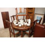 Mahogany circular extending dining table on castors with extra leaf and 6 matching dining chairs (