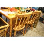 Pine 4 seater table with 4 matching spindle back dining chairs