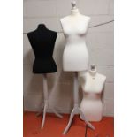 2 mannequins on wooden single pedestal 3 star bases with further mannequin body