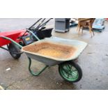 Green framed metal wheelbarrow