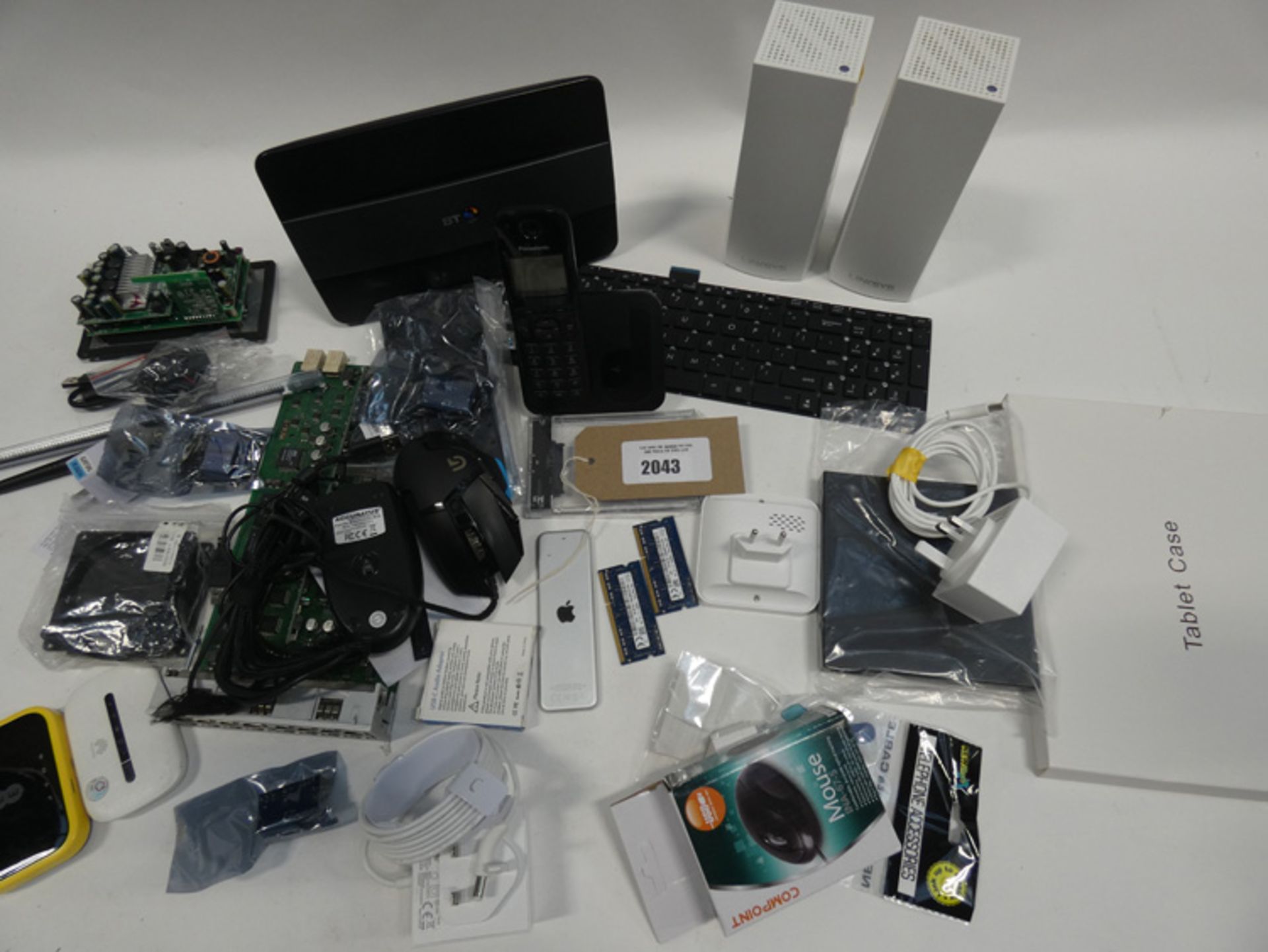 Bag containing network adaptors, Logitech G502 mouse, Apple TV remote A1926, etc.