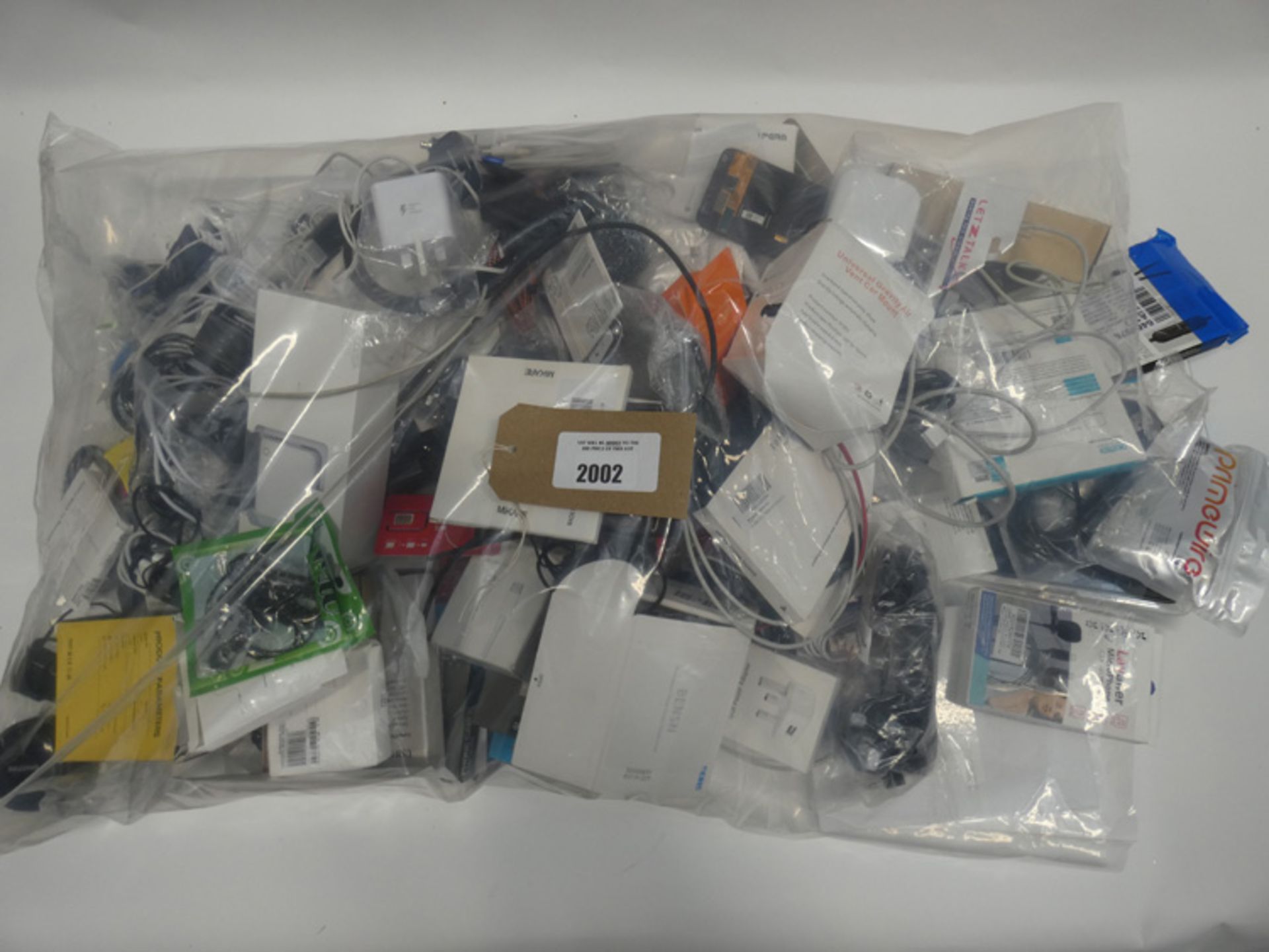 Bag containing quantity of various mobile phone accessories; chargers, earphones, repair kits, power