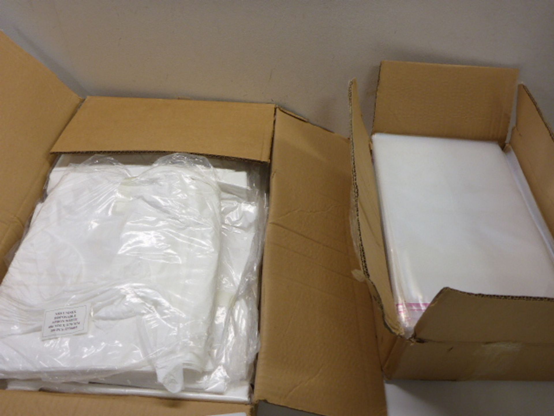 Large box of NHS disposable aprons and large box of self seal plastic bags