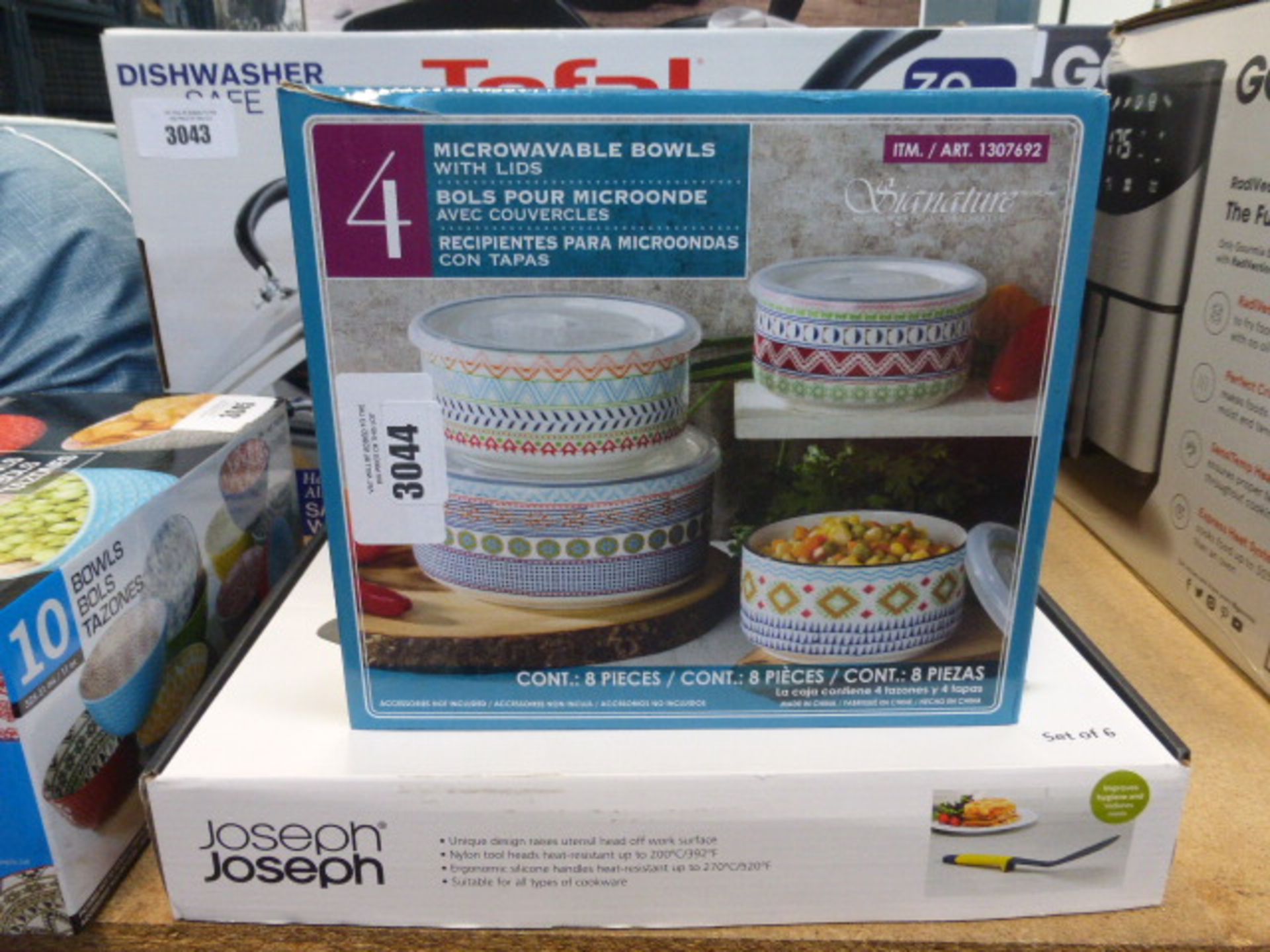 Box of microwavable bowls and a Joseph Joseph kitchen tool set