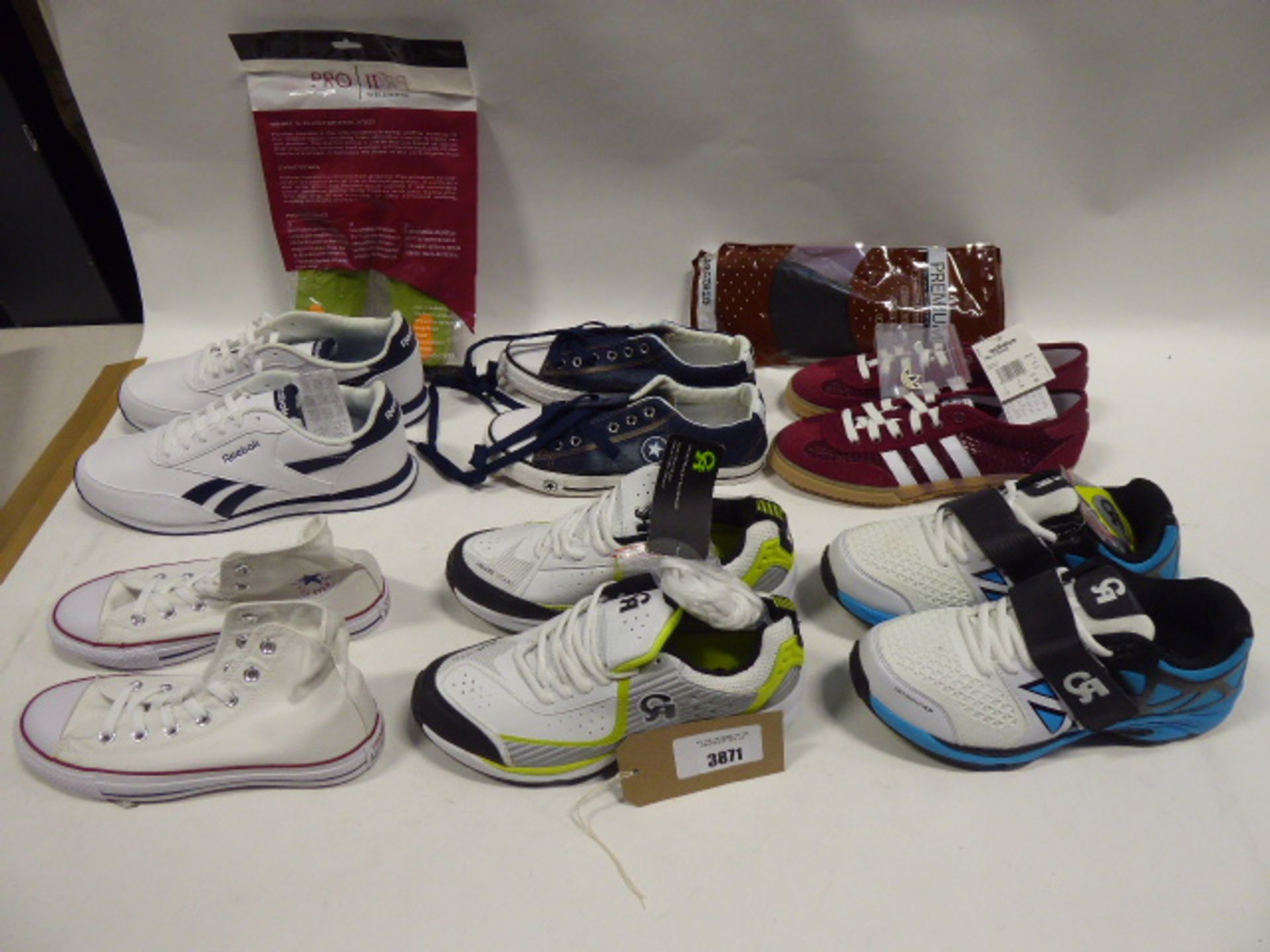 Bag containing assorted trainers and footwear accessories