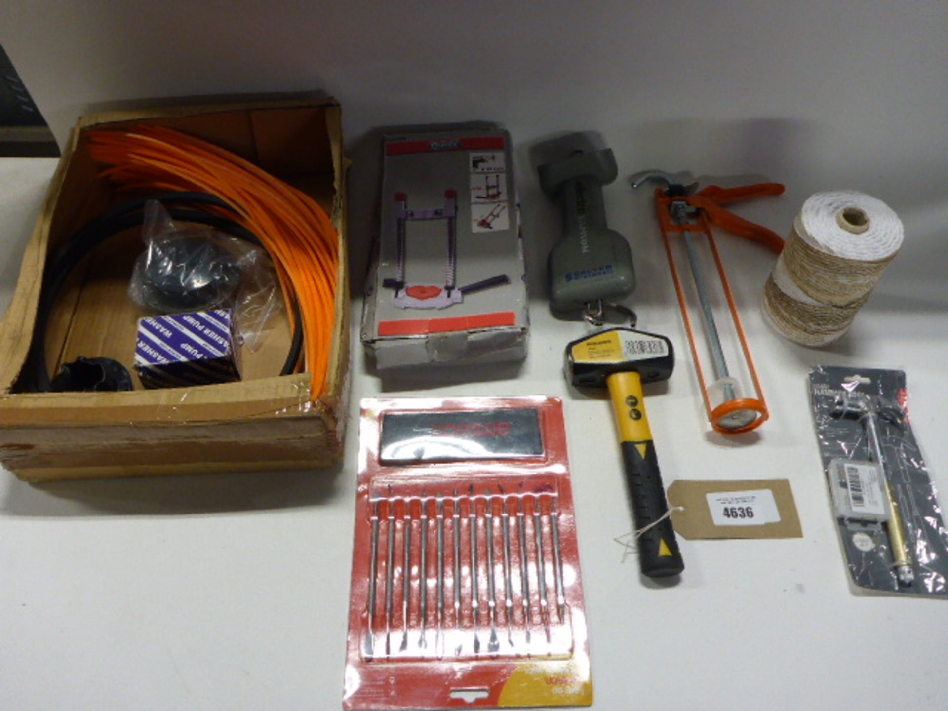 Bag containing strimmer line and heads, drill stands, roughneck hammer, Amtech wax carving set,