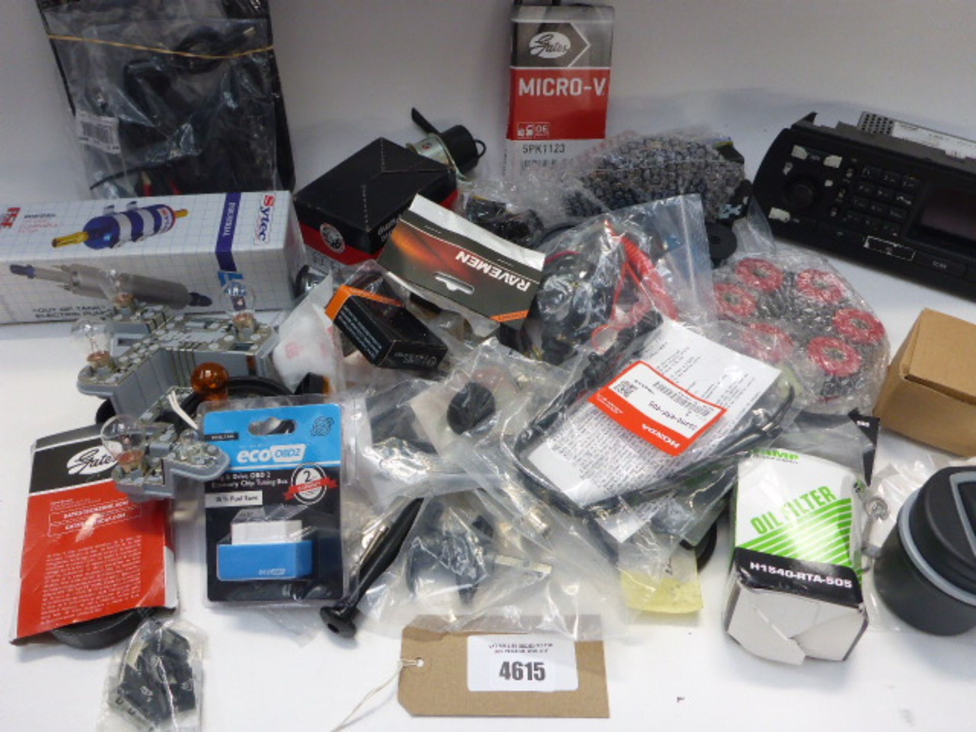 Bag containing car parts and accessories including oil filters, Saab radio, belts, diesel filter,