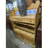 Pine bottle rack with pine double door to base , 2 drawers and a gallery section with blue and white