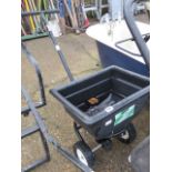 Push along seed spreader