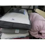 3 various pillows together with a pink sleeping bag