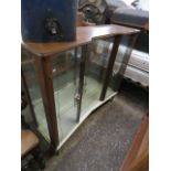 1970's double door glazed display cabinet raised on tapered supports with integral Smiths clock