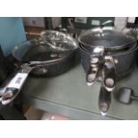 2 Starfrit woks with 3 matching pans and frying pan (used, some with lids)