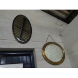 Oval brass wall mirror and an oval mahogany framed and bevelled wall mirror