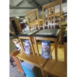 Small rubberwood kitchen table and 2 matching black upholstered chairs