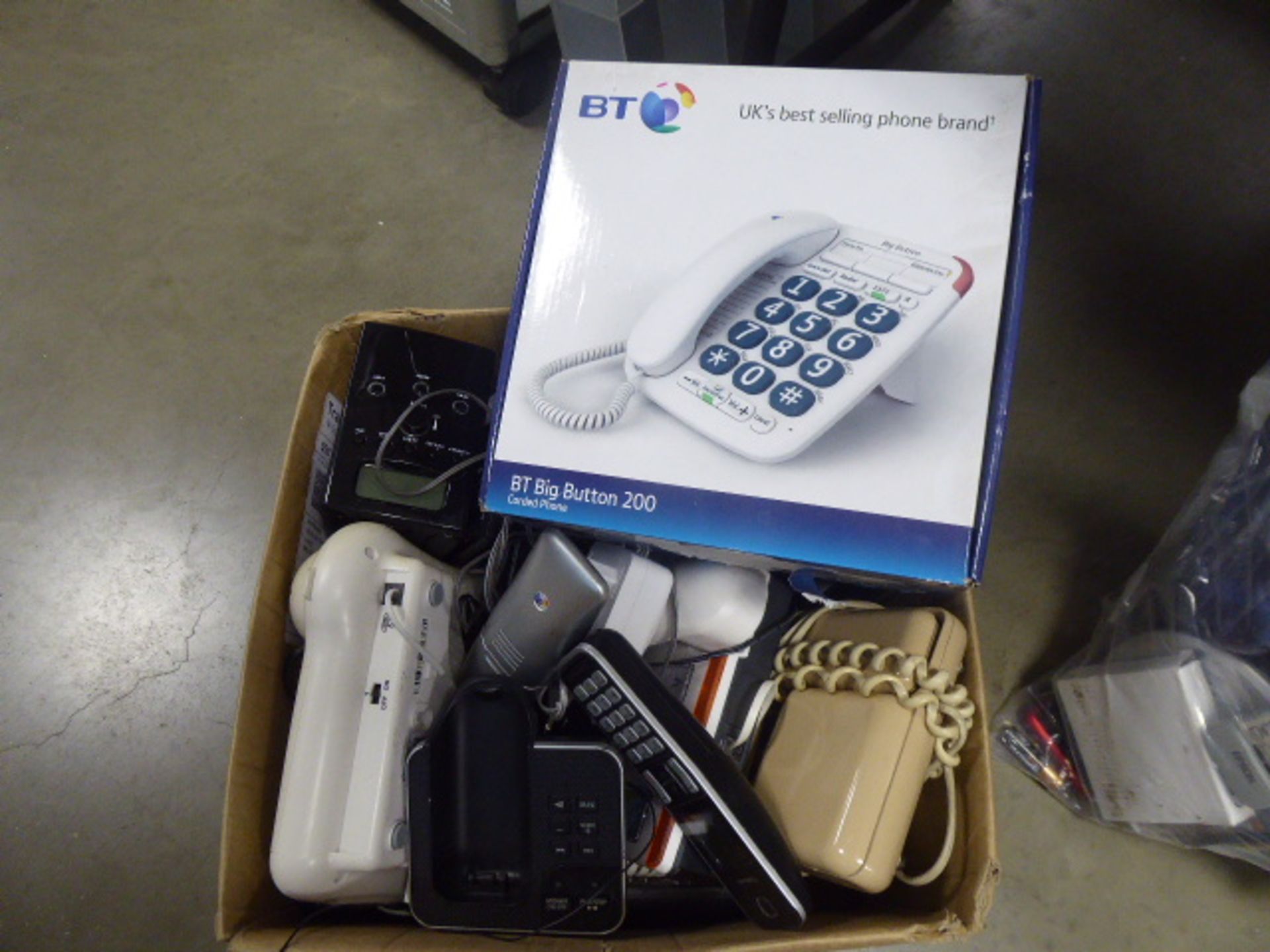 Box containing various telephone handsets, BT handsets, etc