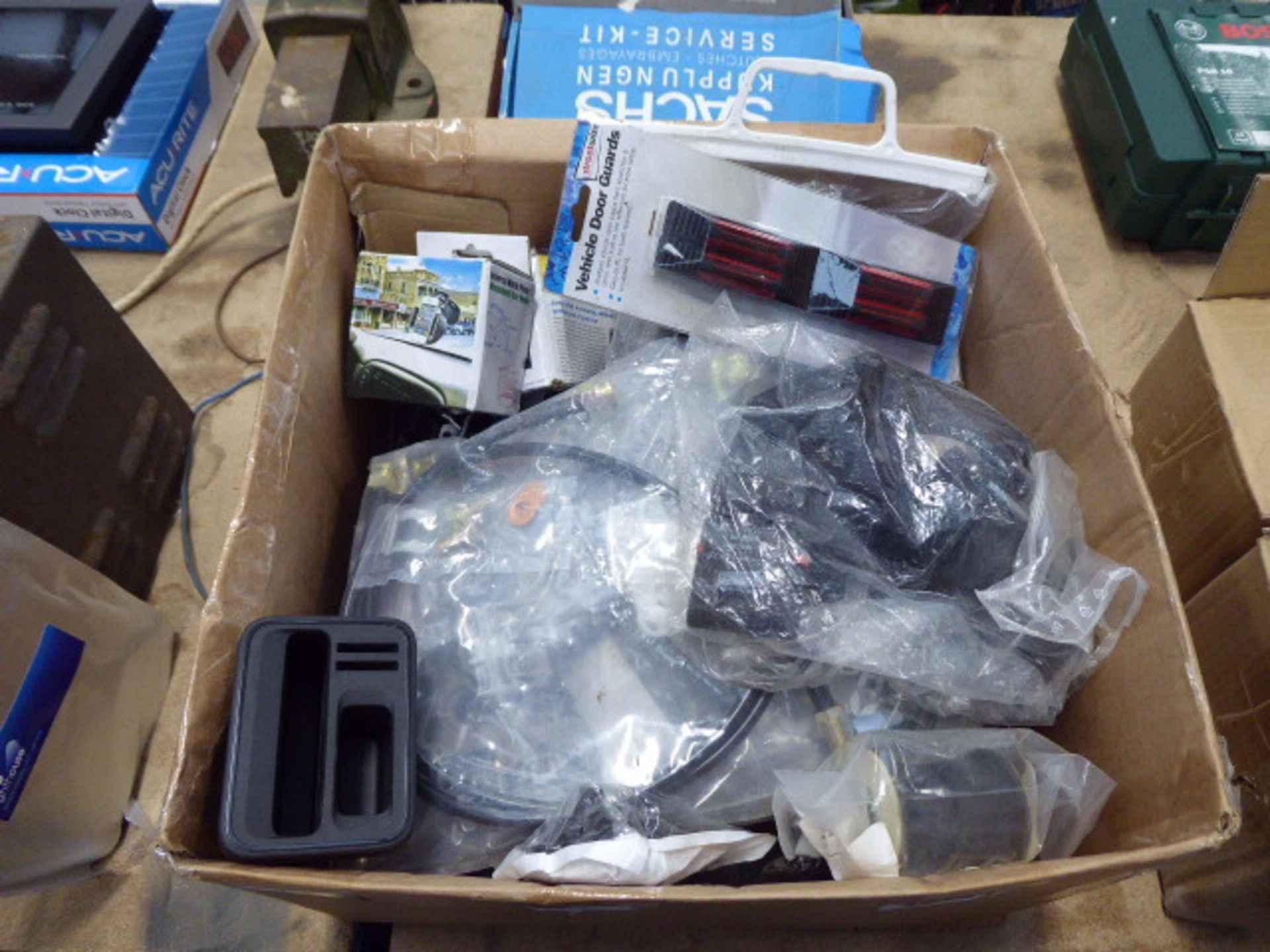 Box of assorted items including, door guards, mud flaps, phone holders and other car related items