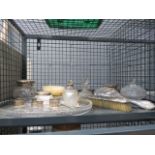 A cage containing silver topped bottles, napkin rings, glass tray, plus brushes and a mirror