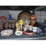 A cage containing a quartz wall clock, sherry and shot glasses, a lustreware bowl, glass fruit bowls