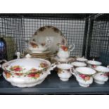 A cage containing a quantity of Royal Albert Old Country Roses pattern crockery