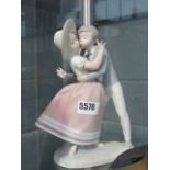 A Lladro figure boy kissing a girl