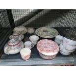 (004) A cage containing rose and floral patterned Masons and other crockery