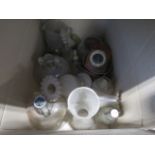 A box containing a soda syphon, oil lamps, demijohn's, decanter and general glassware