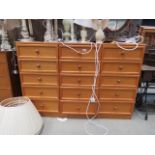 Three narrow teak chests of five drawers