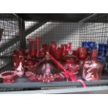 A cage containing Mary Gregory and other cranberry coloured glass