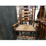 Oak ladder back arm chair with strung seat