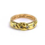 A yellow metal knot-type band ring set four small diamonds, ring size P 1/2, 5.