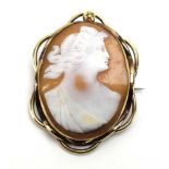 A 19th century yellow metal cameo brooch of oval form depicting a classical female,