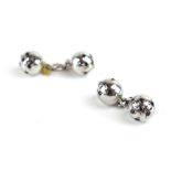 A pair of white metal cufflink's of spherical form,