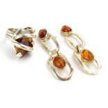 A late 20th century silver dress ring set amber coloured quartz within an entwined setting,